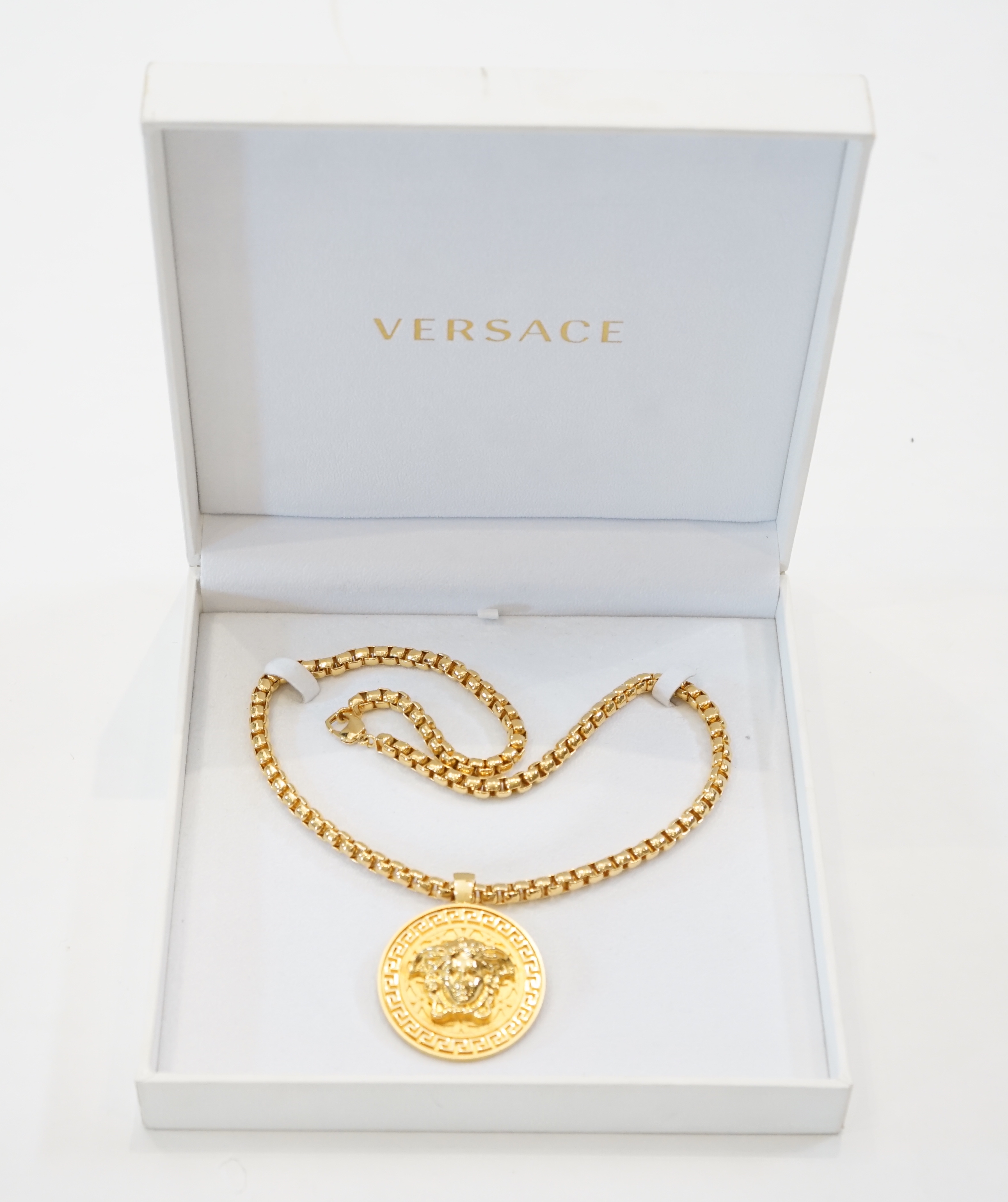 A Versace Medusa gold Greca medallion coin pendant with chunky rapper necklace, chain full length 64cm, medallion 5cm across